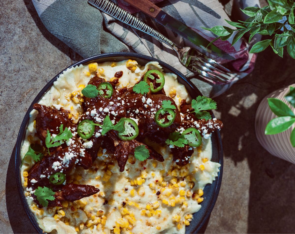 Chicken wing mole with charred corn–jalapeño mac and cheese (© Kristen Penoyer, reprinted from Southern Cooking Global Flavors by Kenny Gilbert / Rizzoli, 2023)