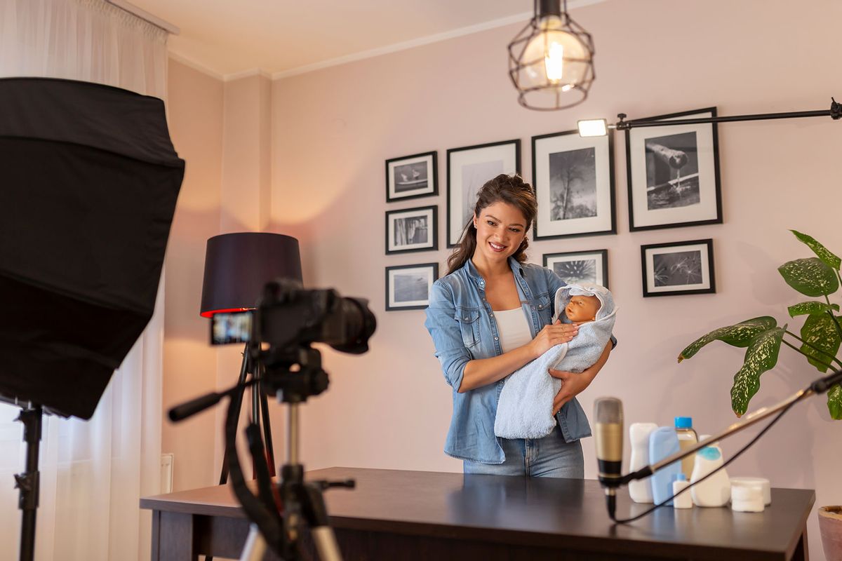 Woman making video about newborn baby handling (Getty Images/vladans)