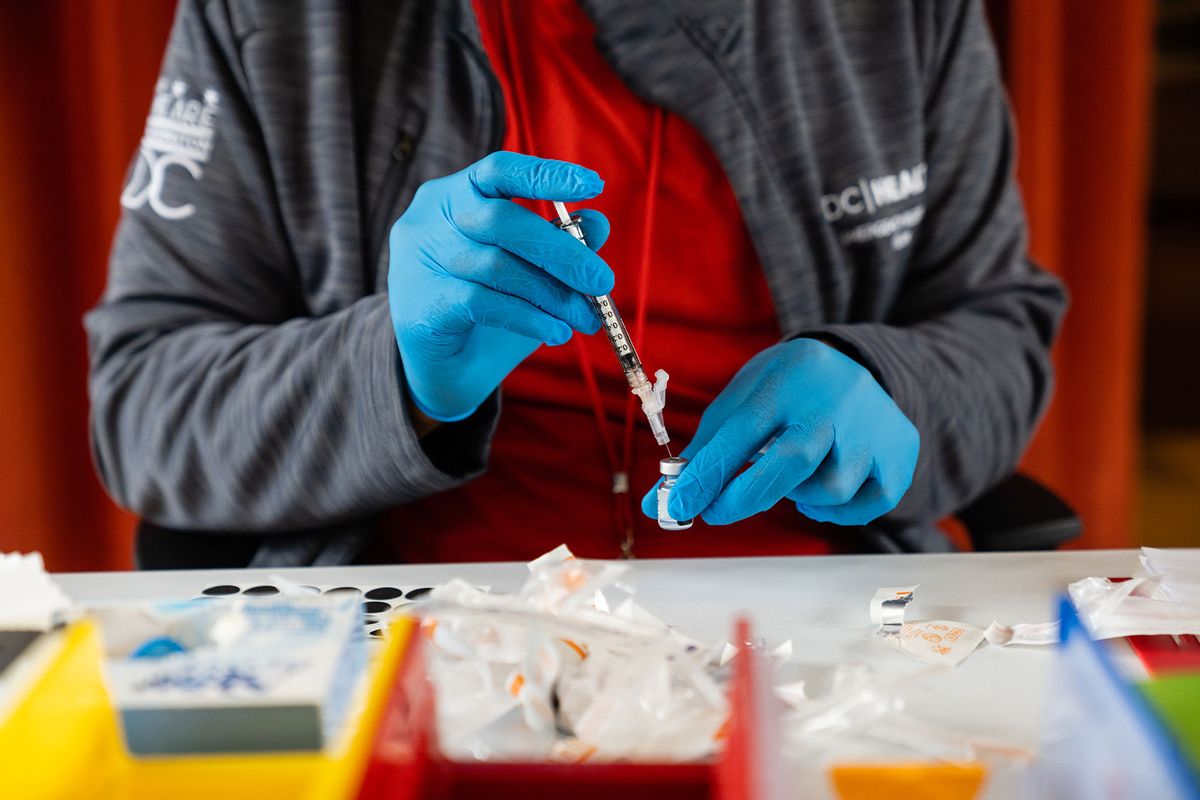 Malik Jaffer, lead nurse, prepares a syringe with a Covid-19 vaccine, at the Peoples Congregational United Church of Christ, the site of the Ward 4 DC Covid Center, in Washington, D.C. on March 31, 2023. (Eric Lee for The Washington Post via Getty Images)