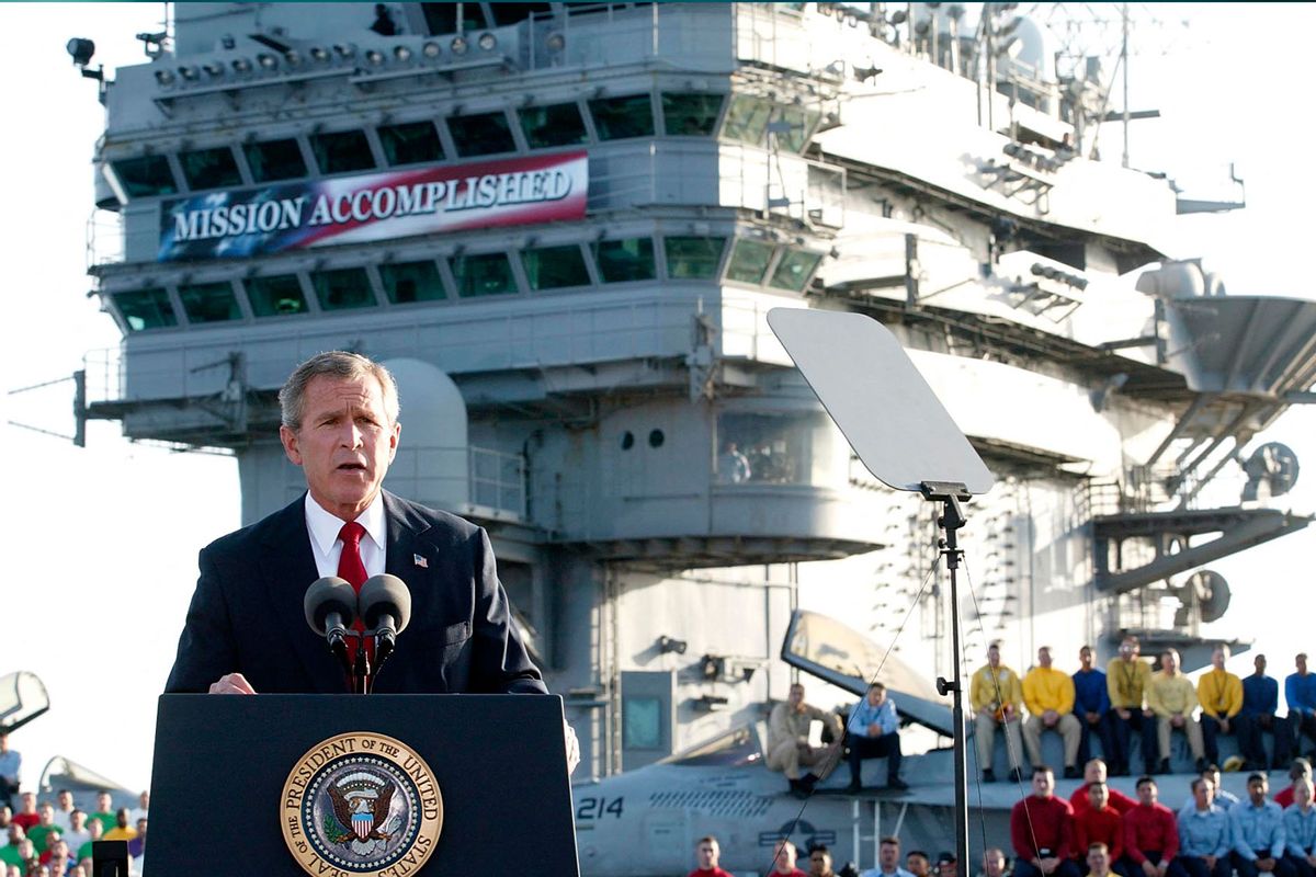 US President George W. Bush addresses the nation aboard the nuclear aircraft carrier USS Abraham Lincoln 01 May, 2003, as it sails for Naval Air Station North Island, San Diego, California. (STEPHEN JAFFE/AFP via Getty Images)