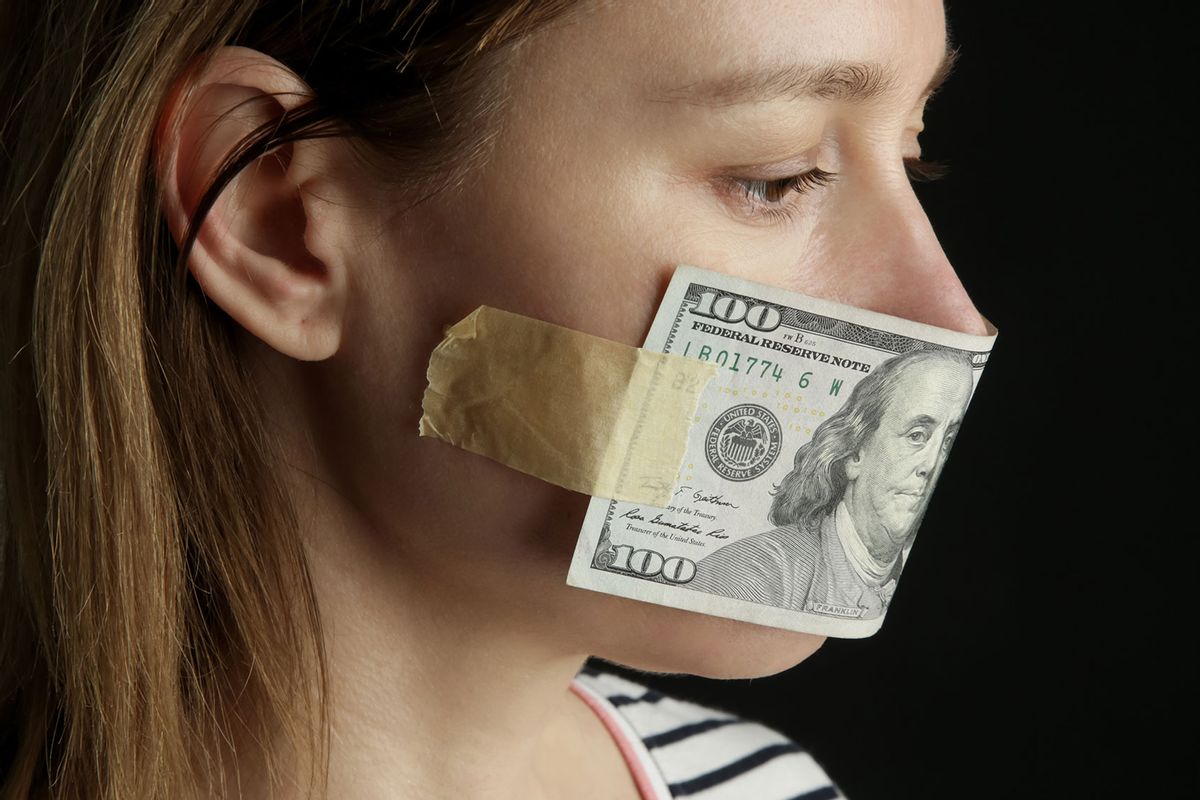 Woman with bill covering mouth. (Getty Images/triocean)