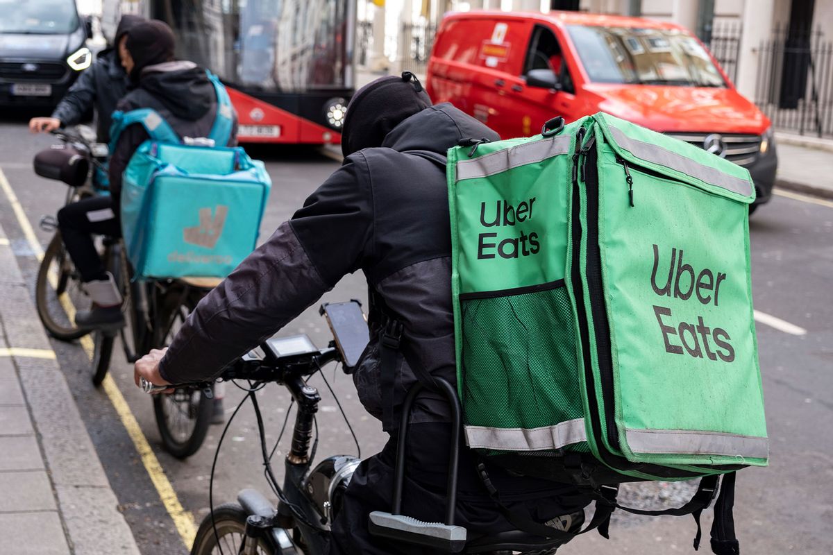 Uber Eats and Deliveroo takeaway delivery cycle couriers (Mike Kemp/In Pictures via Getty Images)