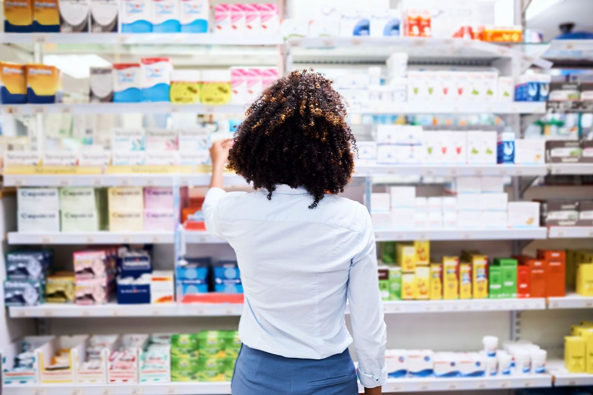 Young woman looking at products in a pharmacy (Getty Images/PeopleImages)