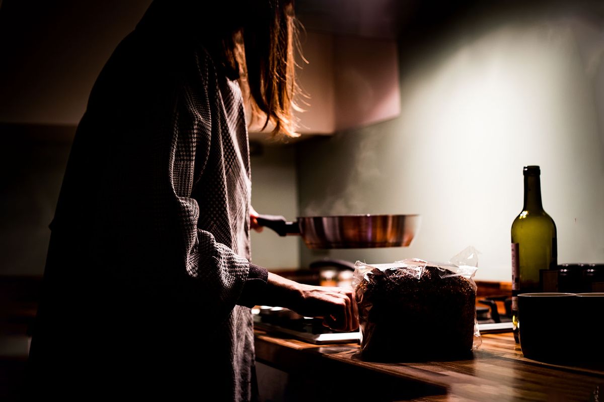 A woman cooking at night in the kitchen (Getty Images/Photographer, Basak Gurbuz Derman)