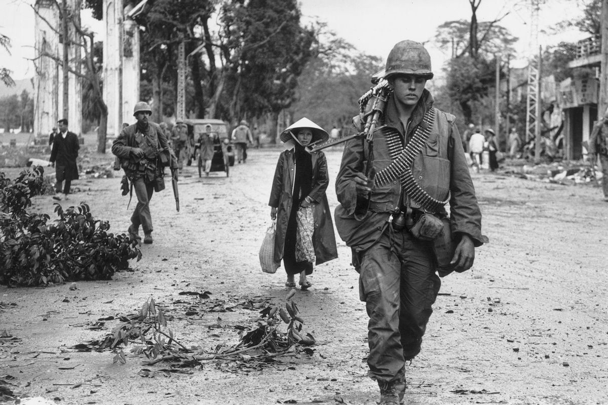 1st March 1968: American soldiers and Vietnamese refugees returning to the town of Hue, in Vietnam. (Terry Fincher/Express/Getty Images)