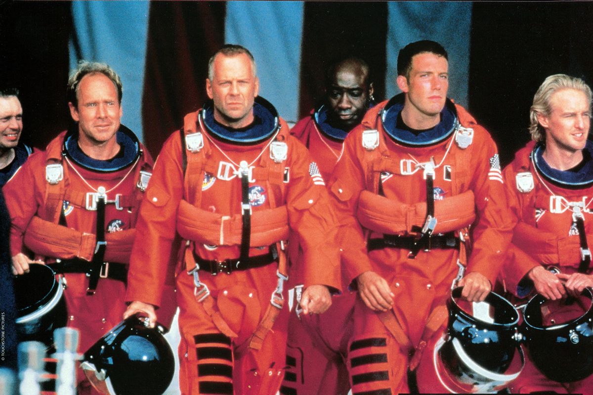 Steve Buscemi, Will Patton, Bruce Willis, Michael Clarke Duncan, Ben Affleck, and Owen Wilson walking in NASA uniforms in a scene from the film 'Armageddon', 1998. (Touchstone/Getty Images)