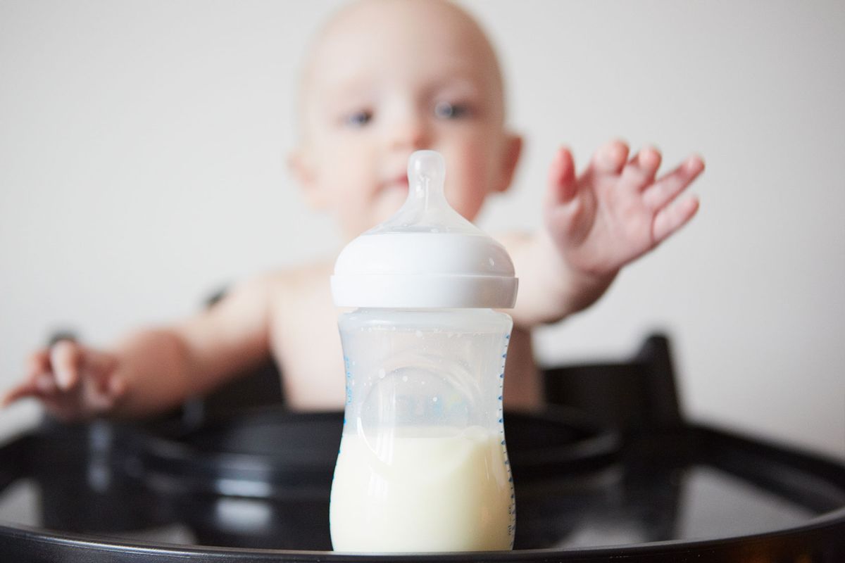 Baby reaching for a bottle (Getty Images/Emma Kim)