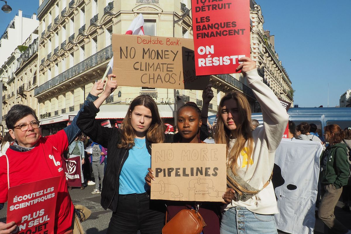 Environmental activists protest against a planned oil pipeline in East Africa in front of the building where the annual general meeting of the French oil and gas giant TotalEnergies is to be held. (Rachel Boßmeyer/picture alliance via Getty Images)