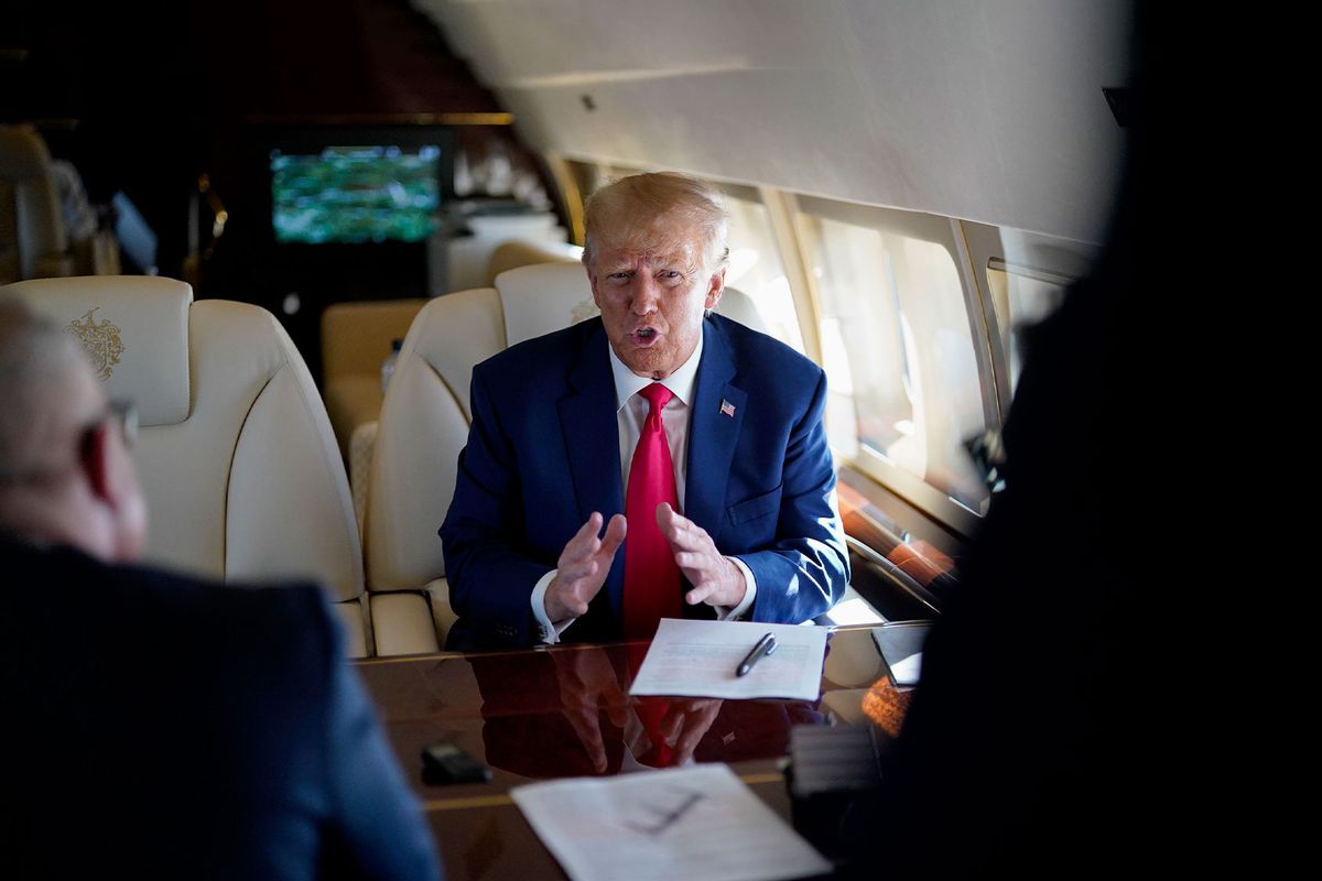 Former president Donald Trump speaks to staff while flying from Georgia to North Carolina, where he was expected to speak at the North Carolina Republican Party's state convention on Saturday, June 10, 2023 in Greensboro, N.C. (Jabin Botsford/The Washington Post via Getty Images)
