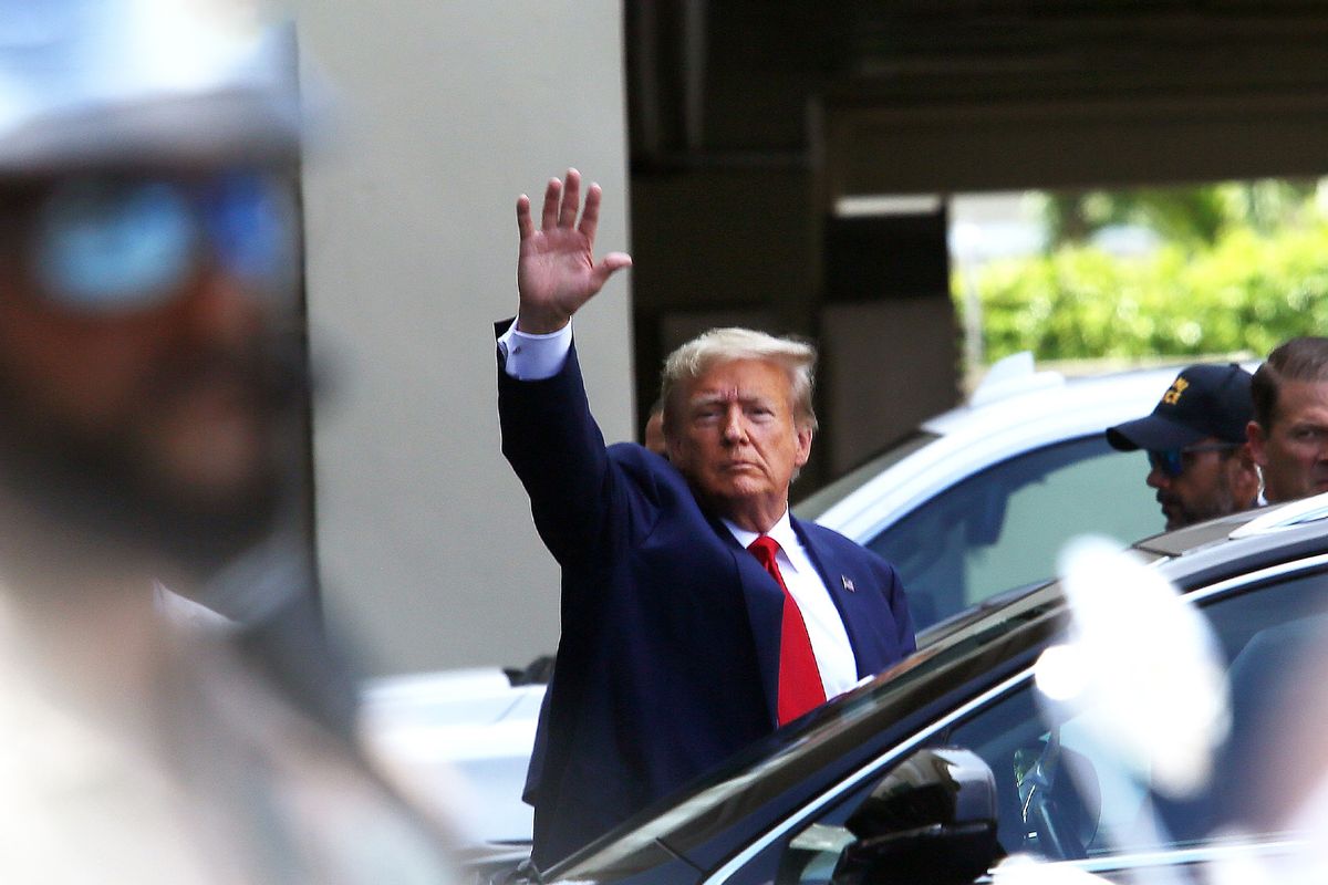 Former U.S. President Donald Trump waves as he makes a visit to the Cuban restaurant Versailles after he appeared for his arraignment on June 13, 2023 in Miami, Florida. (Alon Skuy/Getty Images)