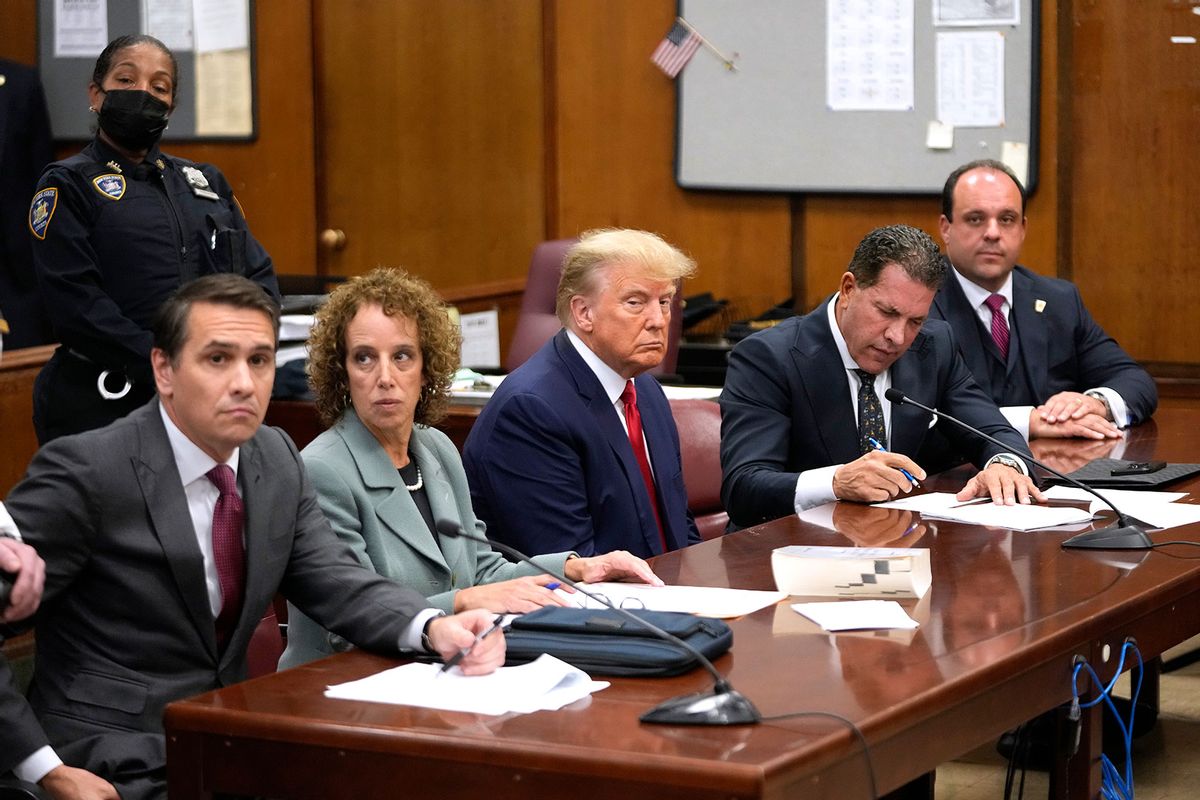 Former U.S. President Donald Trump sits with his attorneys inside the courtroom for his arraignment proceeding at the Manhattan criminal court April 4, 2023 in New York City. (Steven Hirsch-Pool/Getty Images)