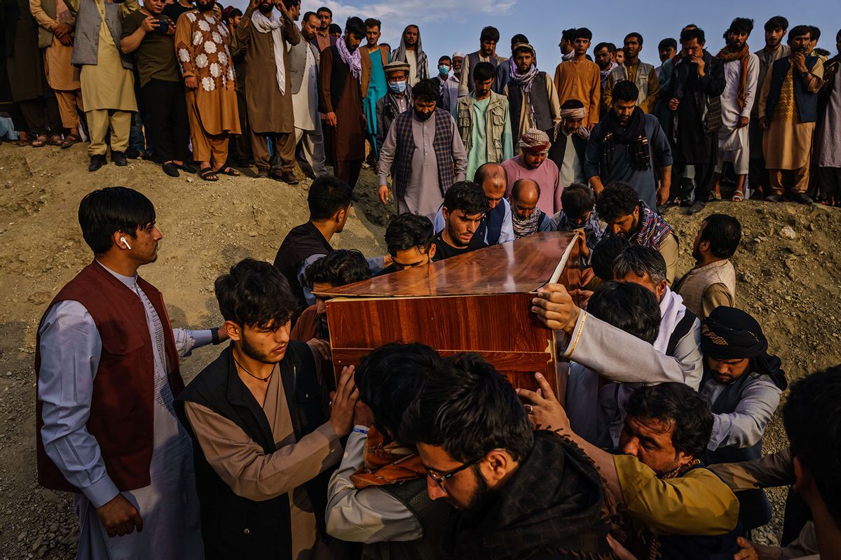 Caskets for the dead are carried towards the gravesite as relatives and friends attend a mass funeral for members of a family that is said to have been killed in a U.S. drone airstrike, in Kabul, Afghanistan, Monday, Aug. 30, 2021. (MARCUS YAM / LOS ANGELES TIMES/Getty Images)