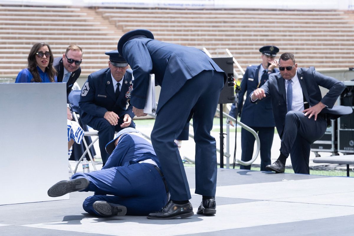 President Joe Biden falls during the graduation ceremony at the United States Air Force Academy, just north of Colorado Springs in El Paso County, Colorado, on June 1, 2023.  (BRENDAN SMIALOWSKI/AFP via Getty Images)