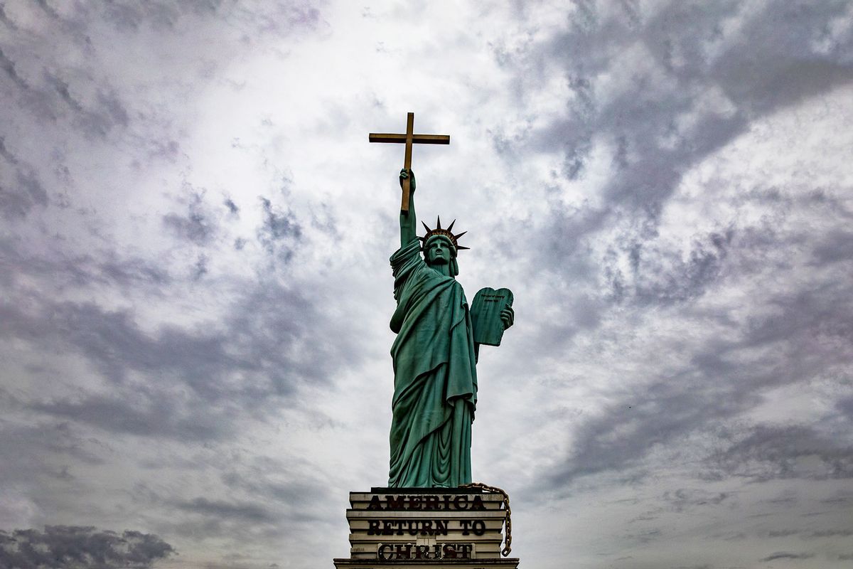 A statue modeled after the Statue of Liberty holds up a cross instead of a torch with "America Return to Christ" outside of World Overcomers Church in Memphis, Tennessee, United States on January 07, 2018. (Samuel Corum/Anadolu Agency/Getty Images)