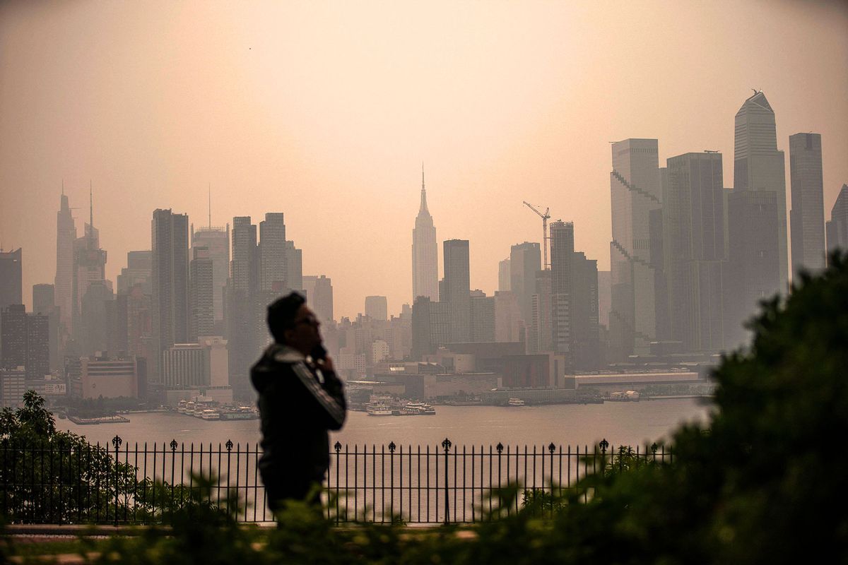 A person looks out at the New York City skyline as it's covered with haze and smoke from Canada wildfires on June 7, 2023 in Weehawken, New Jersey. (Eduardo Munoz Alvarez/Getty Images)