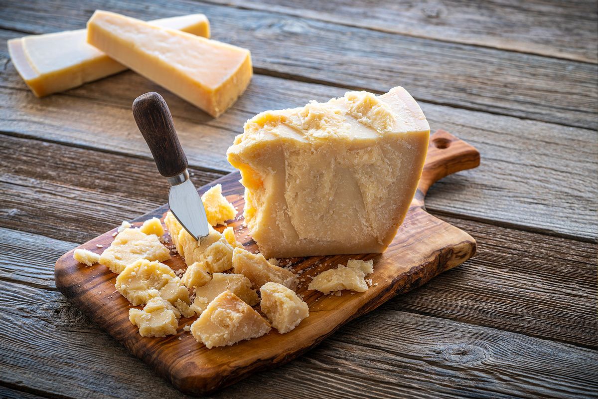 Parmesan Reggiano cheese on cutting board (Getty Images/MEDITERRANEAN)