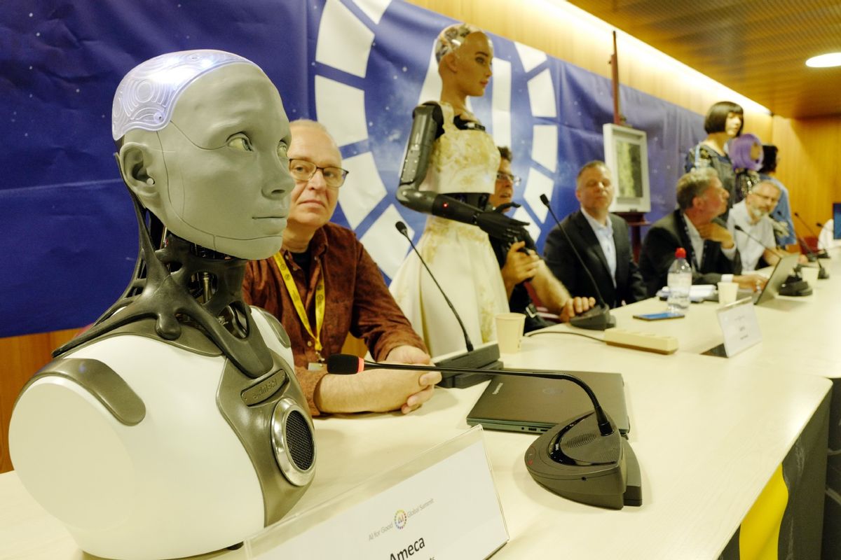 Human shaped robot Ameca (L), beside Will Jackson, CEO and founder of British manufacturer Engineered Arts, addresses the media during a press conference on July 07, 2023 in Geneva, Switzerland. (Johannes Simon/Getty Images)