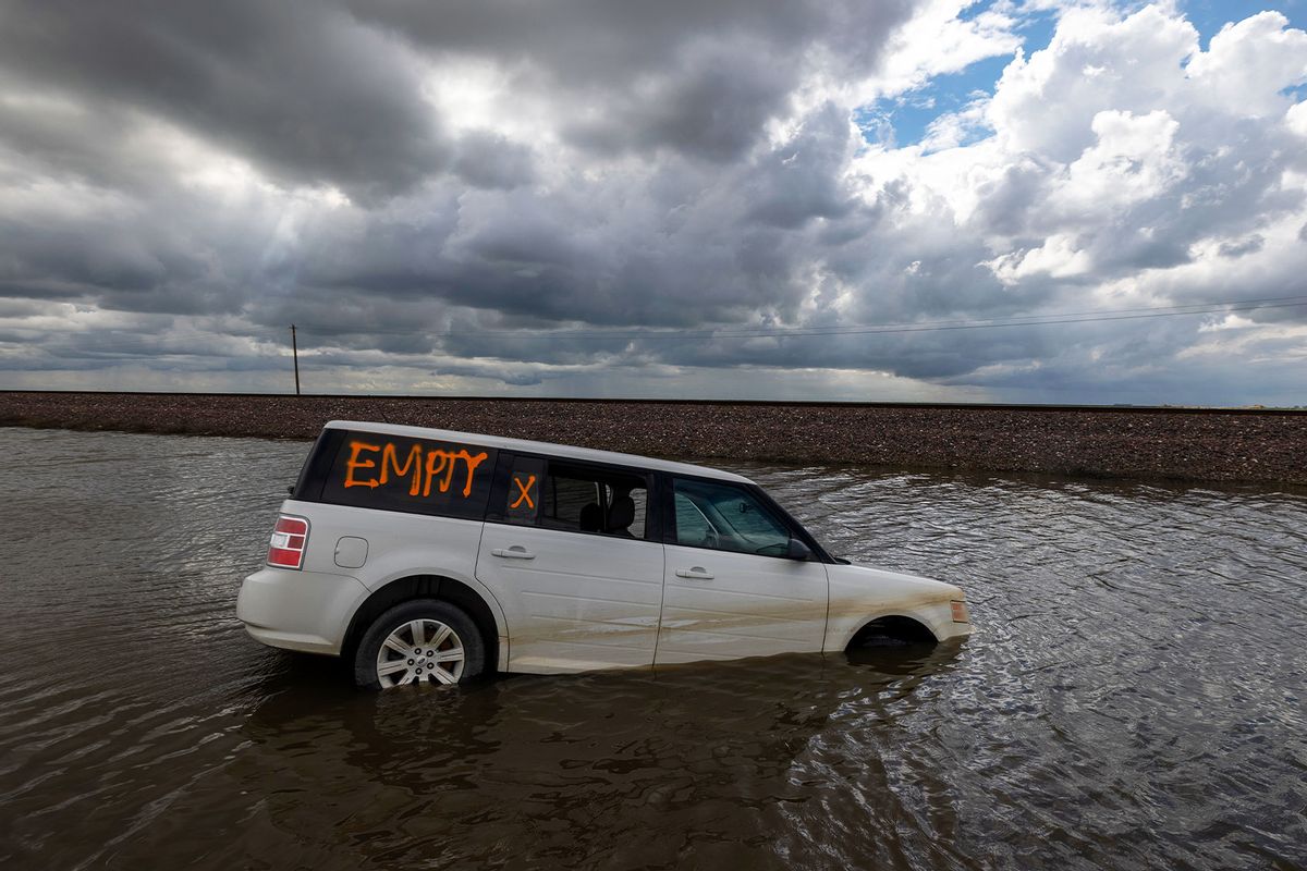 A car is left stranded in widespread flooding as a series of atmospheric river storms melts record amounts of snow in the Sierra Nevada Mountains on March 23, 2023 near Corcoran, California. (David McNew/Getty Images)