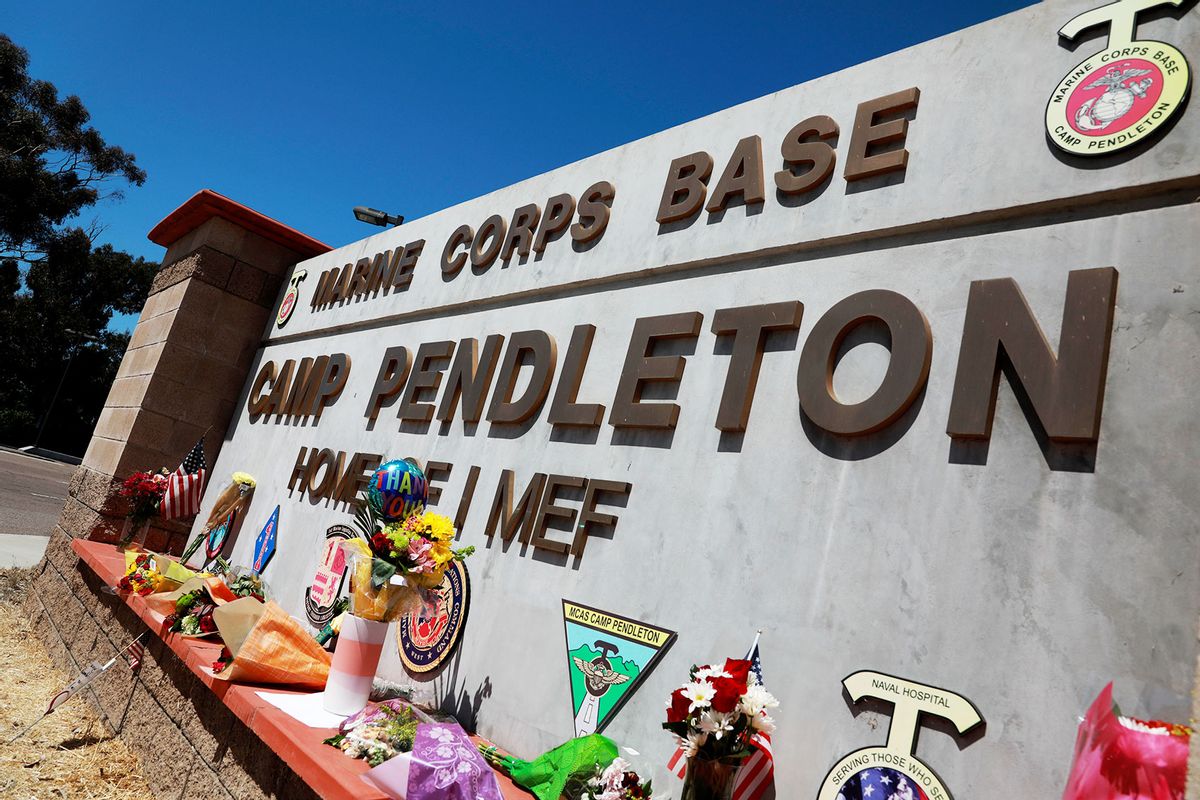 Flowers and other keepsakes adorn the entrance sign to Camp Pendleton on August 27, 2021 in Oceanside, California. (Sandy Huffaker/Getty Images)