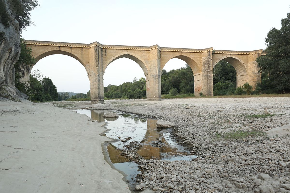 A view of the parched river bed of the Gardon near the Saint-Nicolas de Campagnac bridge in Saint-Anastasie, France on July 20, 2023. France is faced with the risk of drought as heat waves sweep over Europe. (Mohamad Salaheldin Abdelg Alsayed/Anadolu Agency via Getty Images)