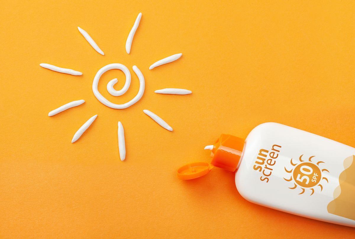Sunscreen on orange background. Plastic bottle of sun protection and white sun-shaped cream. (ADragan via Getty Images) (ADragan via Getty Images)