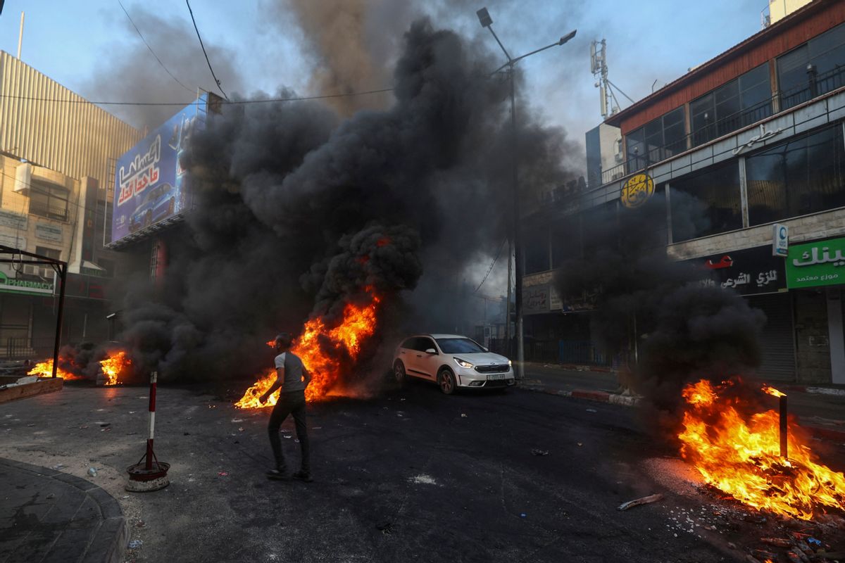Palestinians burn tires and trash during an Israeli military operation in the Jenin refugee camp in the occupied West Bank on July 3, 2023.  (Jaafar Ashtiyeh/AFP via Getty Images)