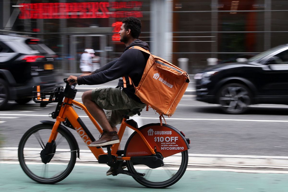 A delivery worker rides his bike on July 07, 2023 in New York City. Grubhub, DoorDash and Uber Eats sued the City of New York on July 6th in order to block its new minimum pay rules for food delivery workers. (Leonardo Munoz/VIEWpress/Getty Images)