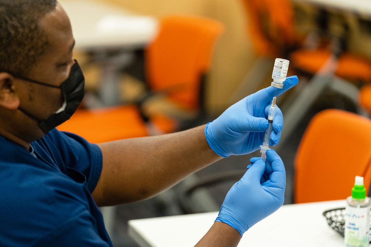 A healthcare employee prepares a syringe with the Moderna COVID-19 vaccine at the Dennis Avenue Health Center in Silver Spring, Maryland on November 21, 2022. (Eric Lee for The Washington Post via Getty Images)