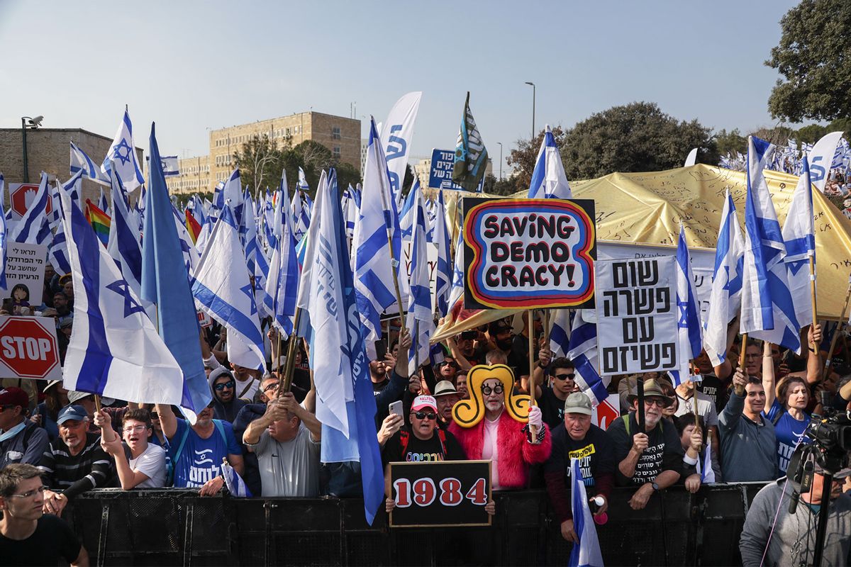 Protesters hold hold Israeli flags and placards infront of the parliament building (Knesset) during a demonstration against judicial reform plans in Jerusalem. (Saeed Qaq/SOPA Images/LightRocket via Getty Images)