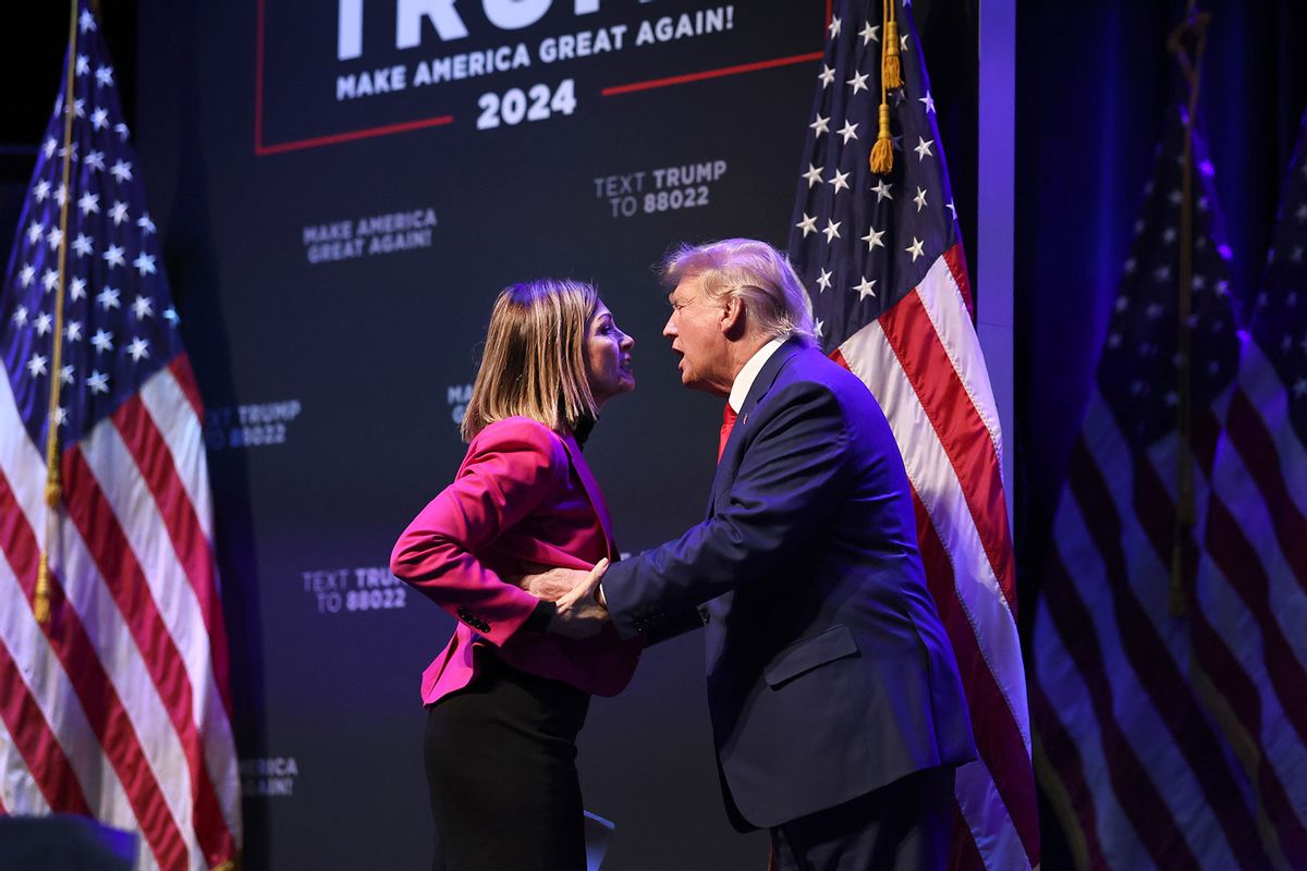 Former President Donald Trump is greeted by Iowa Gov. Kim Reynolds as he arrives for an event at the Adler Theatre on March 13, 2023 in Davenport, Iowa. (Scott Olson/Getty Images)