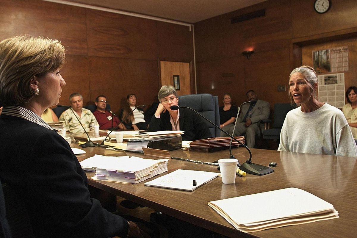 Sheron Lawin (L), a member of the Board of Prison Terms commissioners, listens to Leslie Van Houten (R), after her parole was denied June 28, 2002 at the California Institution for Women in Corona, California.  (DAMIAN DOVARGANES/AFP via Getty Images)