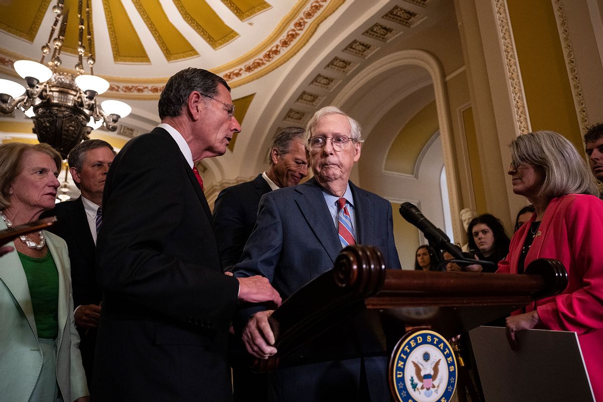 Sen. John Barrasso (R-WY) reaches out to help Senate Minority Leader Mitch McConnell (R-KY) after McConnell froze and stopped talking at the microphones during a news conference after a lunch meeting with Senate Republicans U.S. Capitol 26, 2023 in Washington, DC. (Drew Angerer/Getty Images)