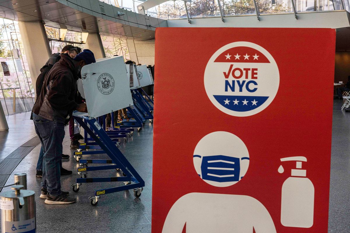 Signs urge voters to remember COVID protocols when voting on November 8, 2022 at the Brooklyn Museum in New York City. (Alex Kent/Getty Images)