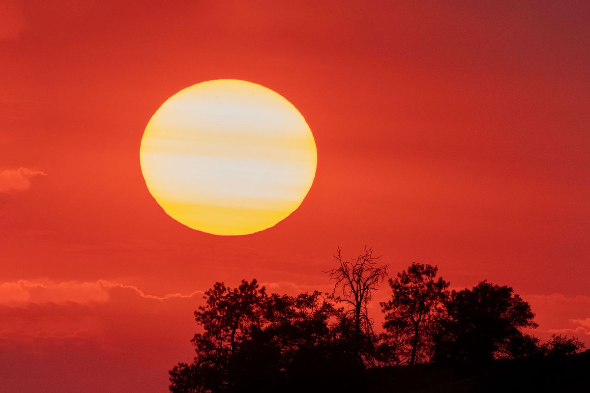 The sun sets behind smoke from a distant wildfire as drought conditions worsen on July 12, 2021 near Glennville, California. (David McNew/Getty Images)