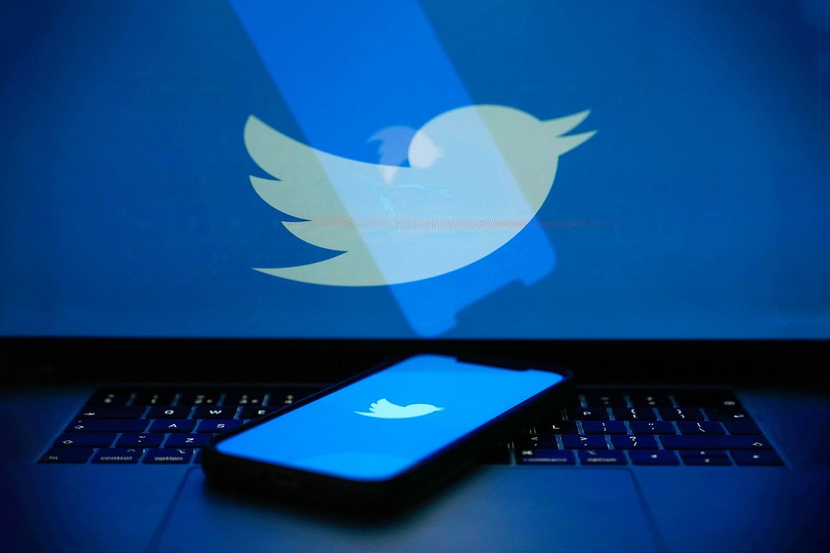 In this photo illustration the Twitter logo is seen on a computer screen and mobile cellphone. (Photo illustration by Christopher Furlong/Getty Images)
