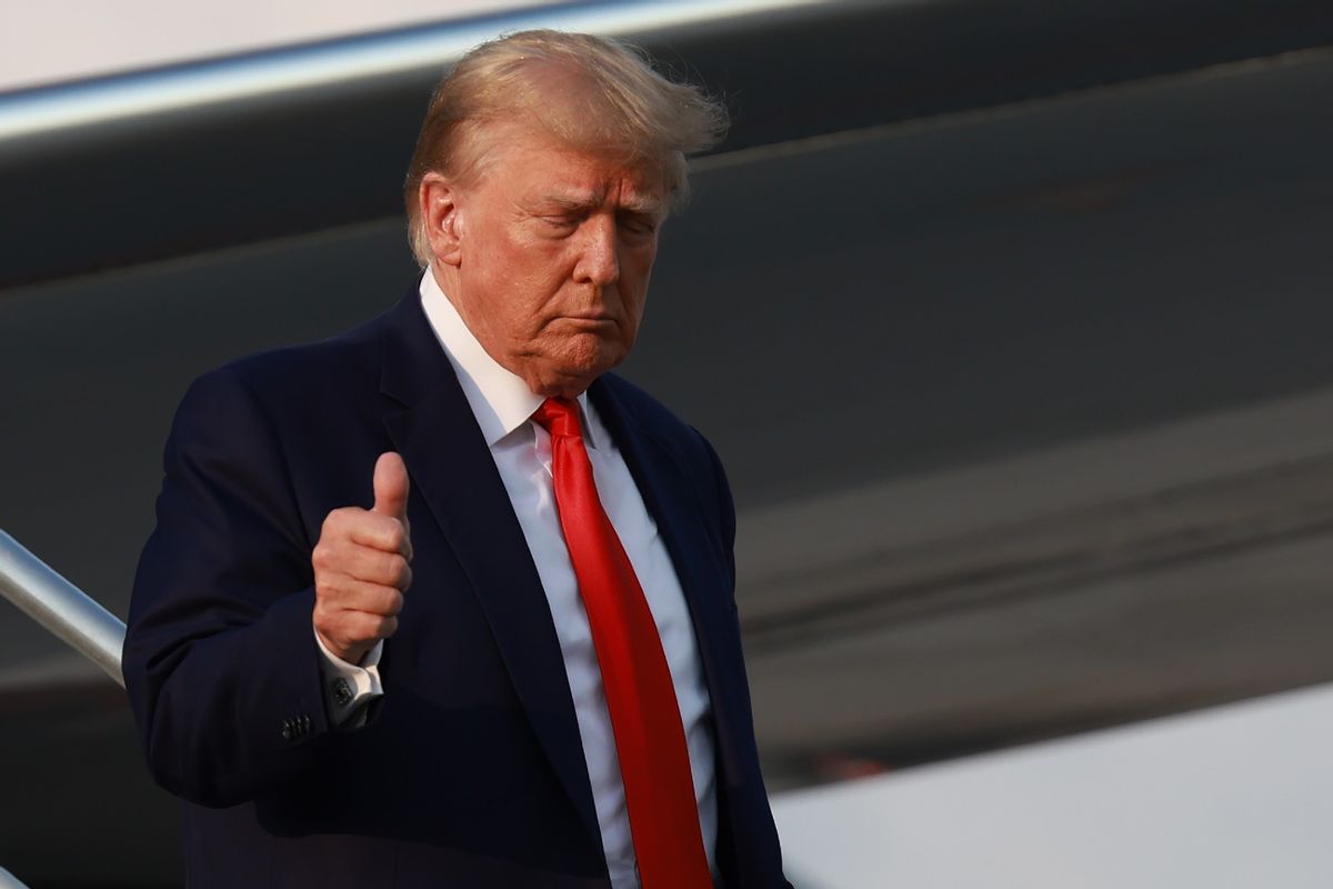 Former U.S. President Donald Trump gives a thumbs up as he arrives at Atlanta Hartsfield-Jackson International Airport on August 24, 2023 in Atlanta, Georgia.  (Joe Raedle/Getty Images)