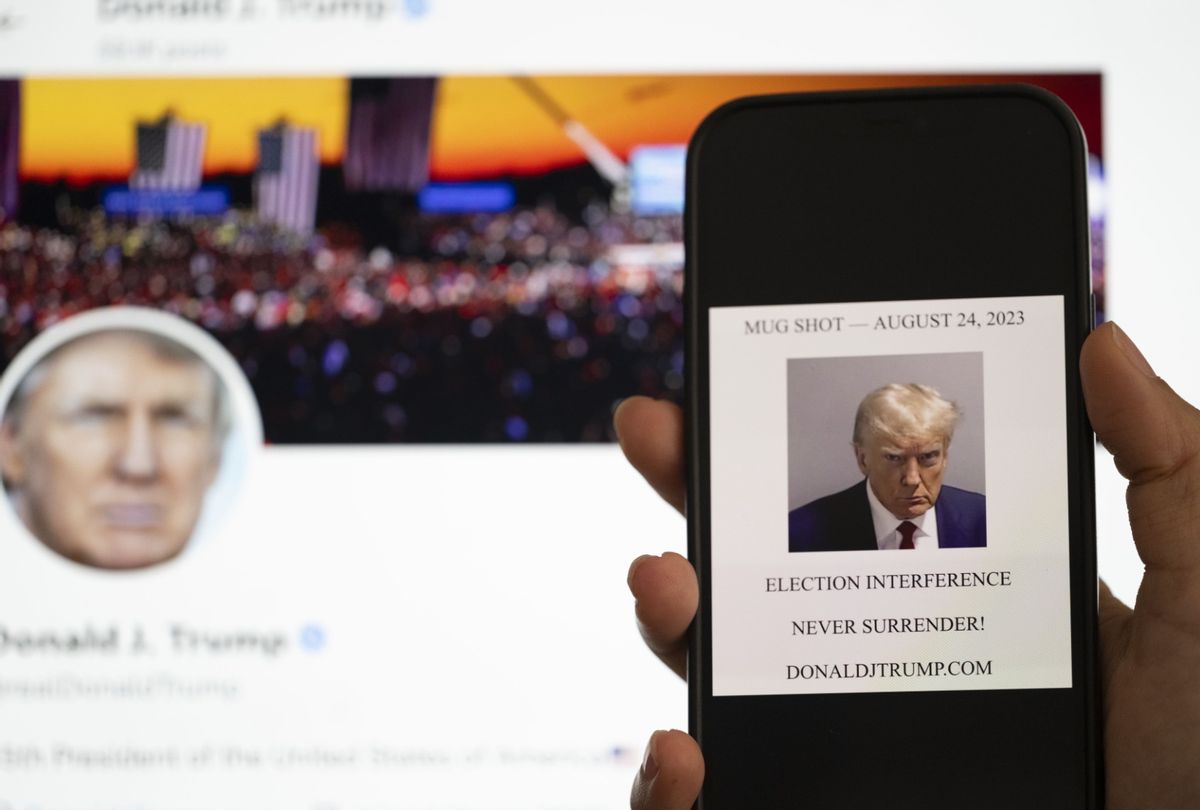 The mugshot of Former U.S. President Donald Trump displayed on a smartphone. (Mustafa Ciftci/Anadolu Agency via Getty Images)
