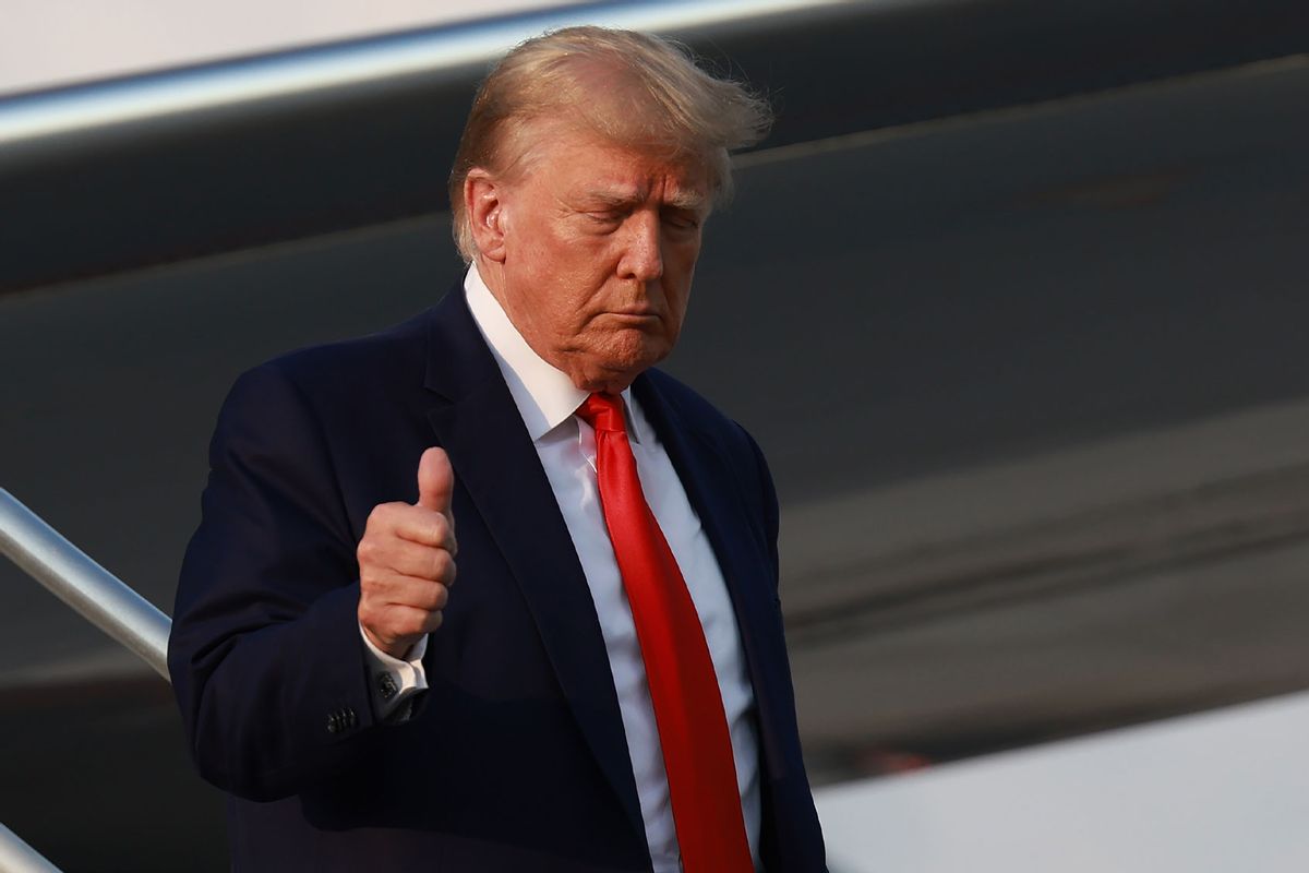 Former U.S. President Donald Trump gives a thumbs up as he arrives at Atlanta Hartsfield-Jackson International Airport on August 24, 2023 in Atlanta, Georgia. (Joe Raedle/Getty Images)