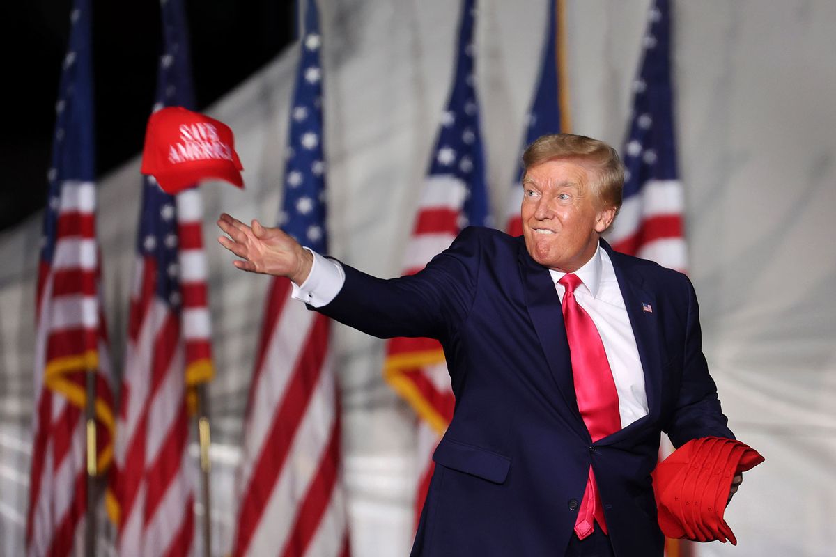 Former President Donald Trump tosses hats to supporters during a rally on August 05, 2022 in Waukesha, Wisconsin. (Scott Olson/Getty Images)