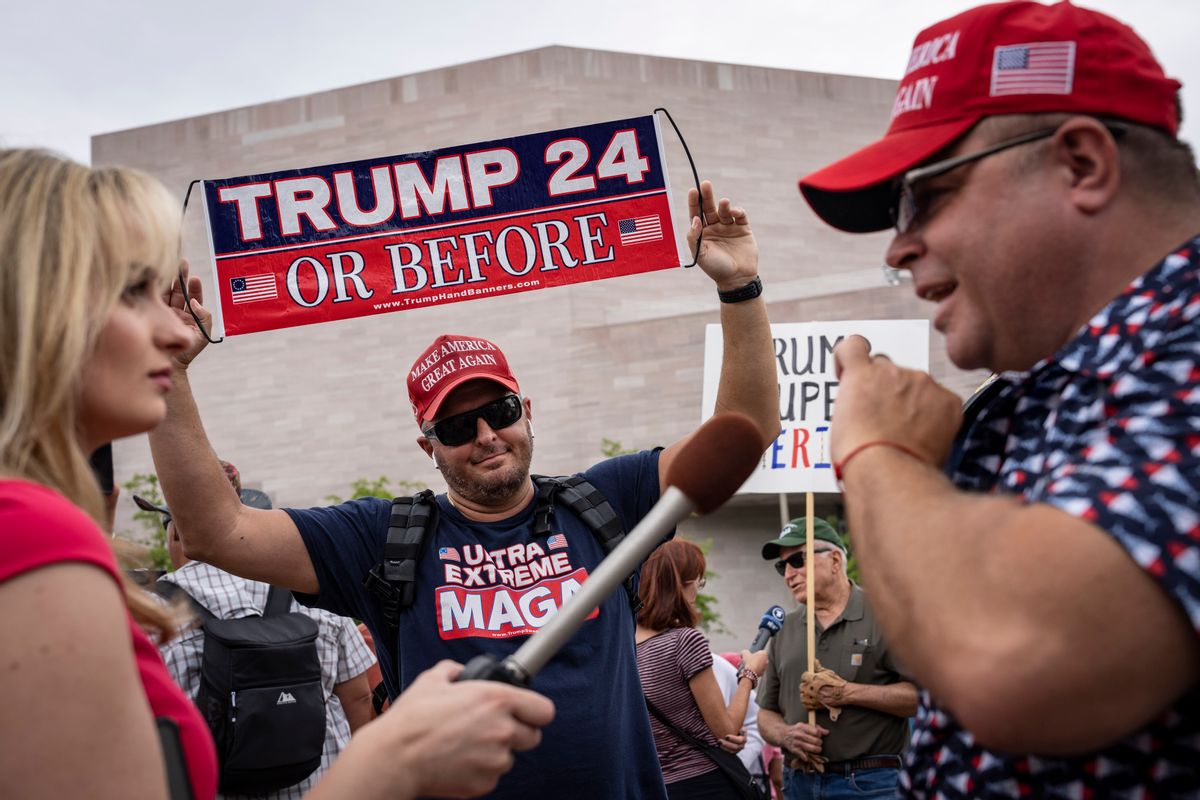 A reporter interviews Donald Trump supporters outside the E. Barrett Prettyman U.S. Courthouse in Washington, D.C., on Aug. 3.  (Drew Angerer/Getty Images)