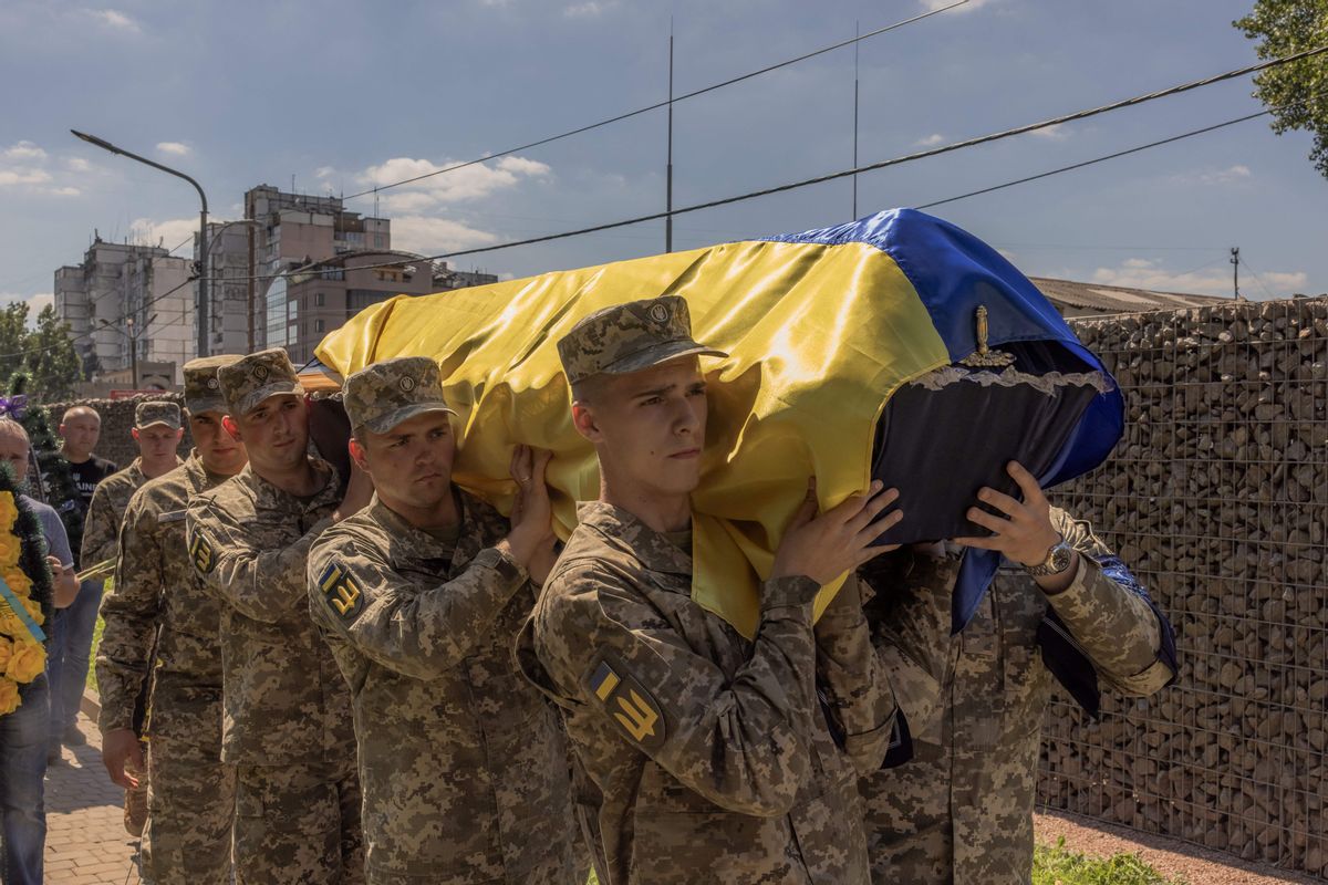 Ukrainian servicemen carry the coffin of Andrii Veremiienko, who was killed fighting Russian troops in the Donetsk region, during a funeral ceremony in Kyiv on Aug. 17, 2023. (Roman Pilipey/AFP via Getty Images)