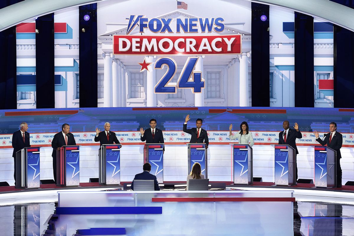 With the exception of former Arkansas Gov. Asa Hutchinson and former New Jersey Gov. Chris Christie, Republican presidential candidates (3rd L-R) former U.S. Vice President Mike Pence, Florida Gov. Ron DeSantis, Vivek Ramaswamy, former U.N. Ambassador Nikki Haley, U.S. Sen. Tim Scott (R-SC) and North Dakota governor Doug Burgum raise their hands to say they would support Donald Trump as the party's presidential nominee during the first debate of the GOP primary season hosted by FOX News at the Fiserv Forum on August 23, 2023 in Milwaukee, Wisconsin. (Win McNamee/Getty Images)