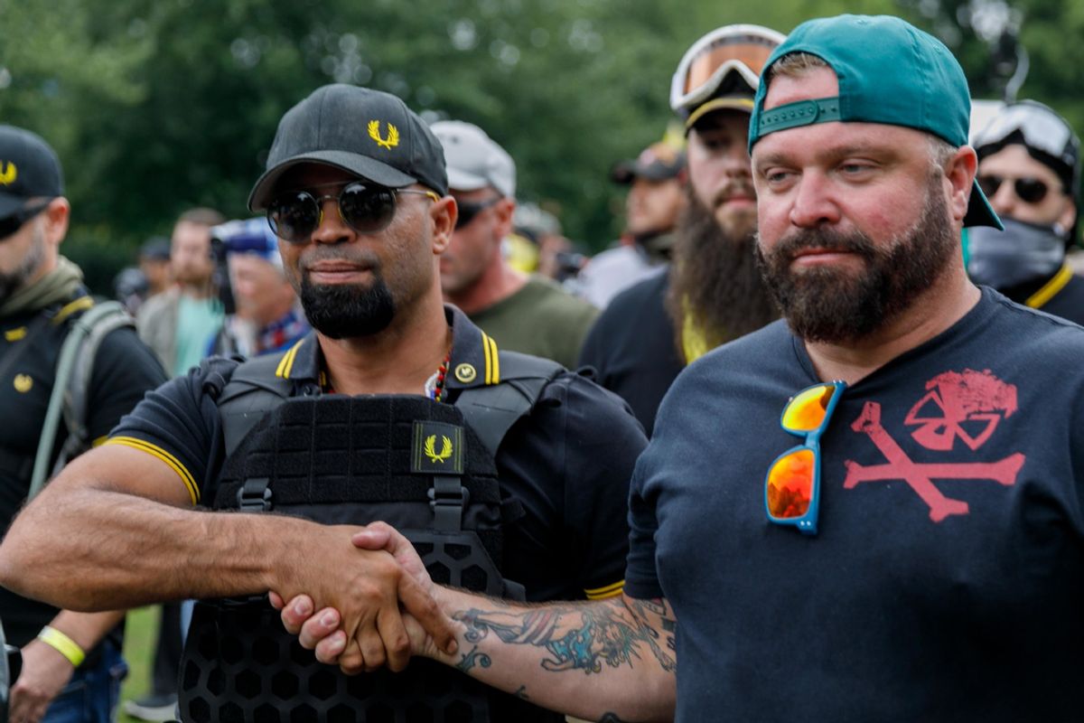 Leader of the Proud Boys Enrique Tarrio (L) and rally organizer Joe Biggs (R) congratulate each other as they return to the march starting-point over the Hawthorn Bridge as "The End Domestic Terrorism" rally at Tom McCall Waterfront Park concludes on August 17, 2019 in Portland, Oregon. (JOHN RUDOFF/AFP via Getty Images)