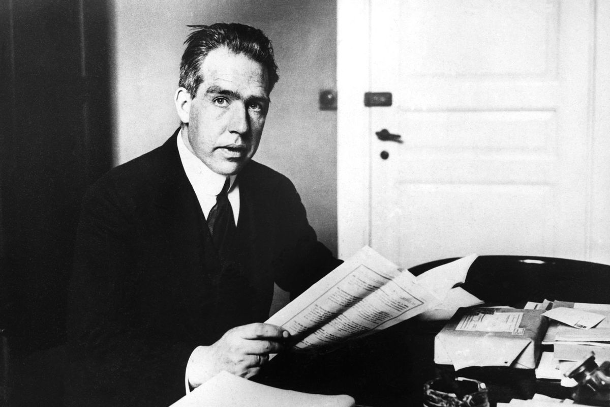 Niels Bohr (1885-1862), Danish physicist. Noble Prize winner, 1922, seated at his desk (Getty Images/Bettmann)
