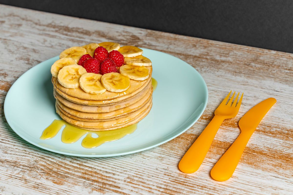 Stack Of Pancakes With Honey, Bananas And Raspberries (Getty Images/Javier Zayas Photography)