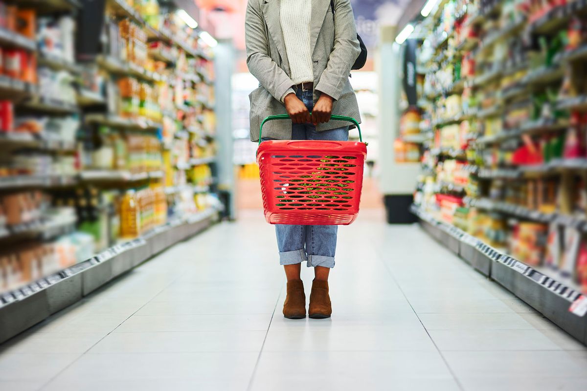 Supermarket aisle, woman legs and basket for shopping in grocery store (Getty Images/Adene Sanchez)