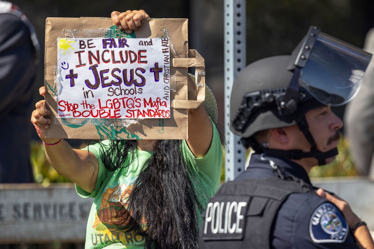 An anti-LGBTQ+ demonstrator carries a sign with an evangelical Christian message outside a Glendale Unified School District (GSUD) Board of Education meeting on June 20, 2023 in Glendale, California. (David McNew/Getty Images)