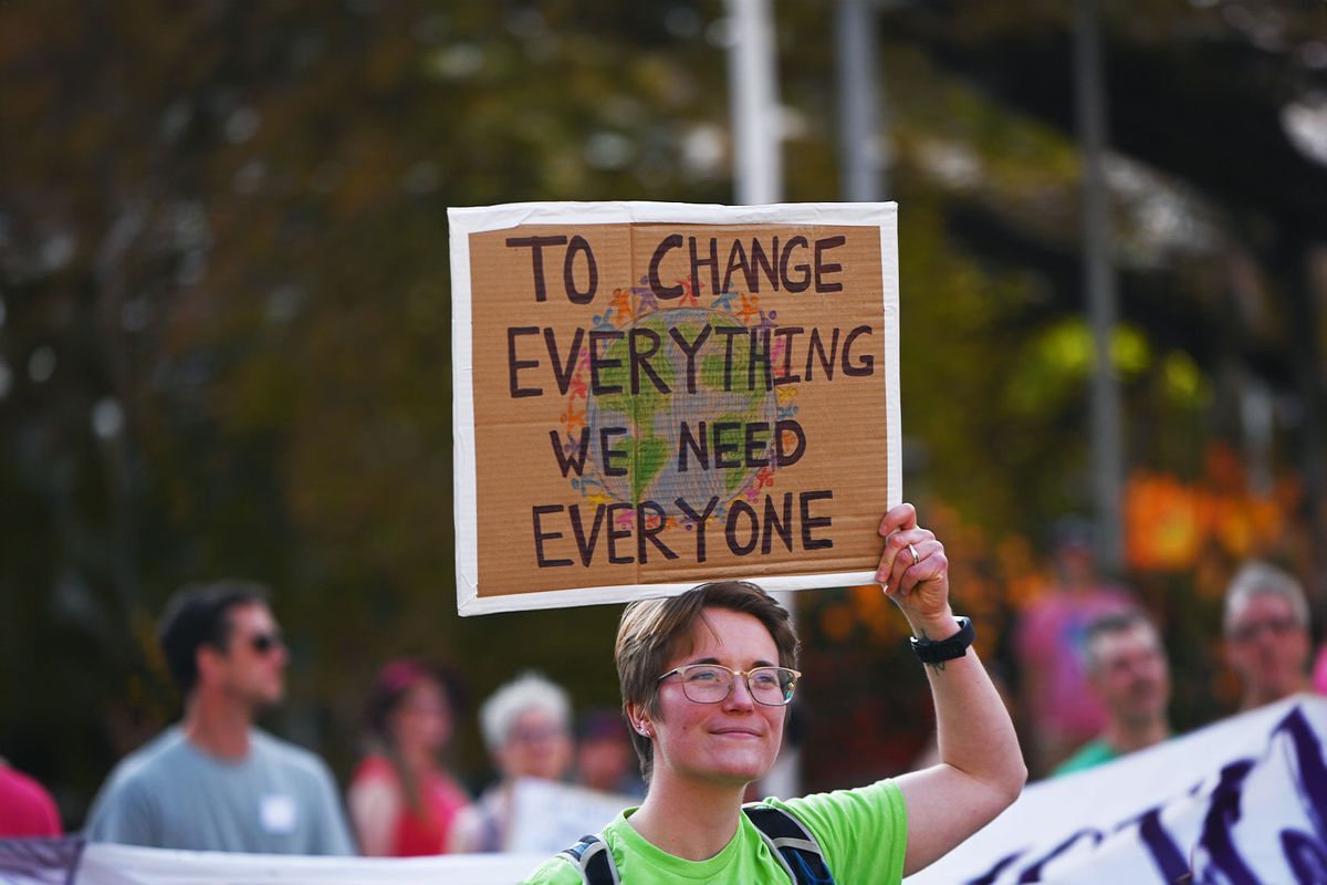 An activist holds placard during a 'Rally for Climate Sanity' outside Calgary's Town Hall in opposition to the 24th World Petroleum Congress Opening Ceremony, on September 17, 2023, in Calgary, Canada. (Stringer/Anadolu Agency via Getty Images)