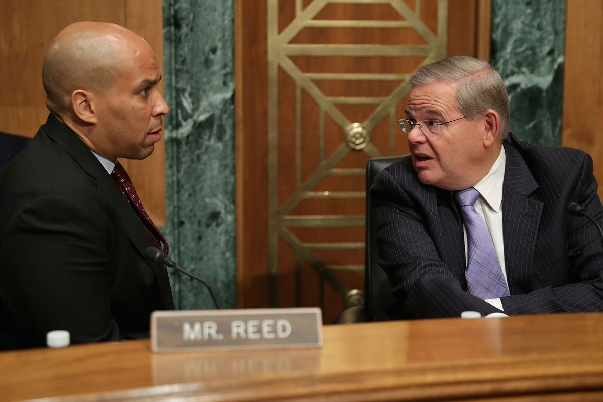 Robert Menendez (D-NJ) (R) talks with Sen. Cory Booker (D-NJ) before a hearing at the Dirksen Senate Office Building on Capitol Hill July 30, 2014 in Washington, DC. (Chip Somodevilla/Getty Images)