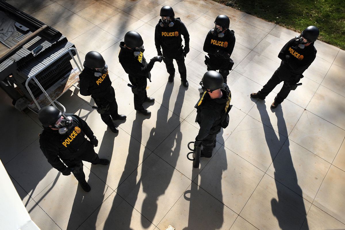 US Drug Enforcement Administration (DEA) Agents simulate a raid in their Tactical Training Facility, part of the new National Clandestine Laboratory Training and Research Facility December 5, 2008 at the DEA Training Academy in Quantico, Virginia. (TIM SLOAN/AFP via Getty Images)
